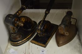Two cast iron office presses and an old flat iron.