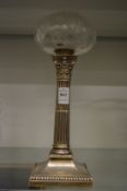 A silver Corinthian column form oil lamp base with cut glass reservoir.