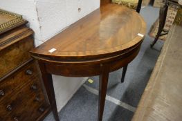 A mahogany demi-lune fold-over card table.