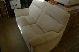 A Parker Knoll two seater settee and matching ottoman foot stool.