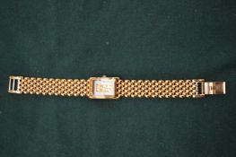 Ladies gilt metal wristwatch, the dial mounted with fine gold ingot.