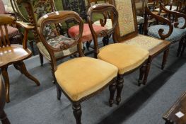 A pair of Victorian oak dining chairs.