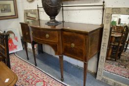 A George III style mahogany sideboard with brass galleried back, bow fronted central section.