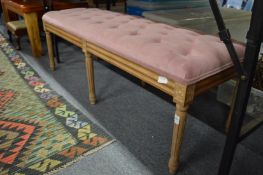 A long upholstered beech framed stool.