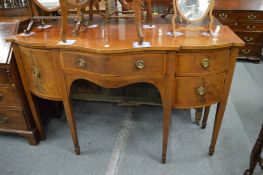 A Georgian style inlaid mahogany serpentine fronted sideboard.