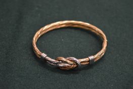A rope twist bangle, stamped 9K