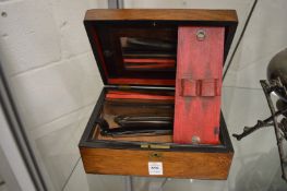 A Victorian gentleman's rosewood vanity case containing cut throat razors etc.