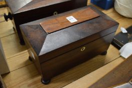 A Victorian rosewood sarcophagus shaped tea caddy.