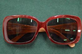 Cased pair of reading glasses.