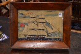 A 19th century sailors wool work picture depicting a two masted sailing ship in a mahogany frame.