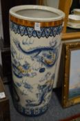 A Chinese pottery stick stand decorated with dragons.