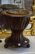 A Dutch mahogany jardiniere with a brass liner.