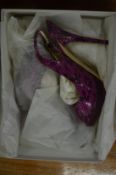 Jimmy Choo, a pair of magenta coloured ladies high heeled shoes, size 38.5.