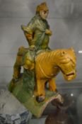 A Chinese pottery ridge tile modelled as a man on horseback.