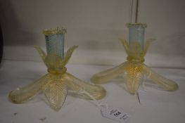 A pair of decorative glass candlesticks, possibly Murano.