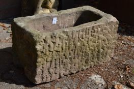 A reconstituted stone plant trough.