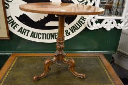 A Victorian inlaid walnut tripod table.