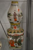 A Chinese colourfully decorated gourd shaped vase.