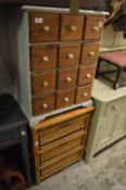 A small multi-drawer chest and a pine and wicker storage chest.
