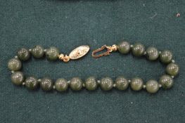 A jade bead bracelet.