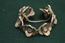 A silver and mother of pearl flower bracelet.