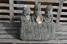 A reconstituted stone garden ornament modelled three gnomes.