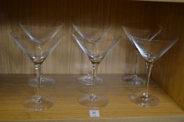 A set of six martini glasses.