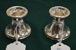 A pair of dwarf silver candlesticks.