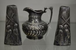A pair of D M F small silver plated tapering vases depicting scenes of a Dutch boy and girl together