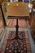 A 19th century mahogany adjustable music stand with tripod base.