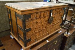 An Eastern carved hardwood and metal bound trunk.