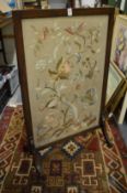 Mahogany framed fire screen with silk work embroidered panel.