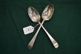A pair of Georgian silver tablespoons with bright cut decoration.