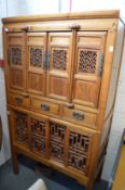 A Chinese soft wood cabinet on stand.