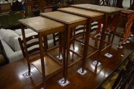 A nest of four decoratively painted tables.