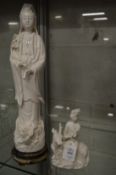A blanc de chine figure of Guanyin on a deer together with a large standing Guanyin.