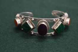 A silver bracelet set with various hard stones.