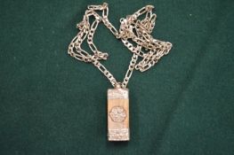 A silver chain and pendant.