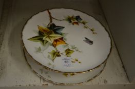 Porcelain tazza painted with flowers and butterflies together with a matching plate.