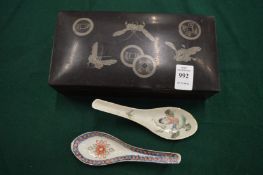A Japanese lacquer cigarette box and two Chinese porcelain spoons.