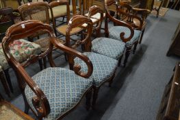A set of four Victorian mahogany dining chairs, two with arms.