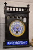 A Victorian aesthetic movement mantel clock with blue and white enamel dial.