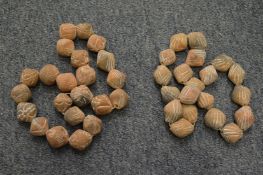 Two carved terracotta beaded necklaces,