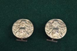 A pair of silver replica coin cufflinks.