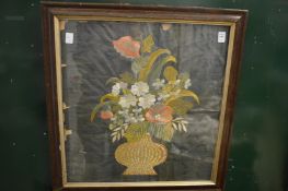 An embroidered and metal thread picture depicting a still life of flowers in a vase, framed and