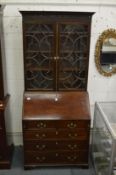 A good Chippendale style mahogany bureau bookcase with well fitted interior and carved decoration.