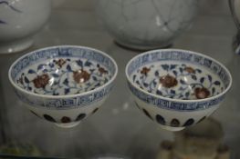 A pair of Chinese blue and iron red bowls.