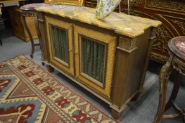 A decoratively painted side cabinet with wire work doors and faux marble top.
