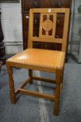 A Knightman carved oak dining chair.