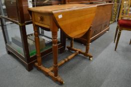 An unusual 19th century fruit wood drop-flap occasional table on turned supports.